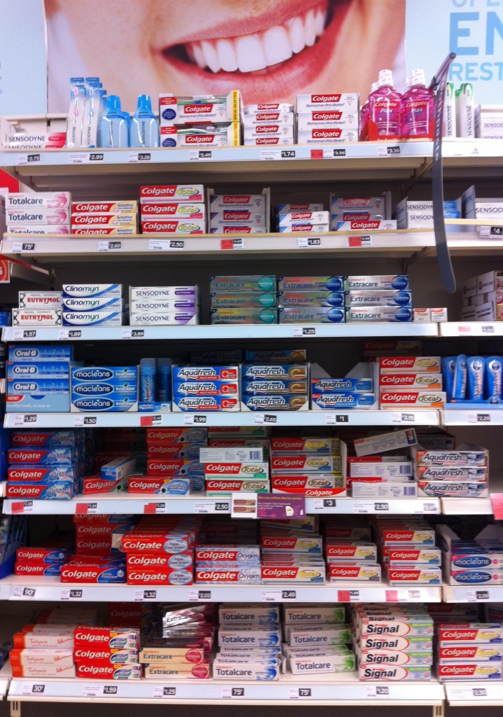 Toothpaste display in Sainsbury Photograph of seven shelves filled with different brands and types of toothpaste at Sainsbury supermarket